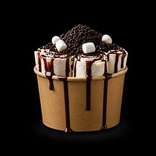 Rolled ice cream bar at Charming Cafe — five curls with crumbs and toppings